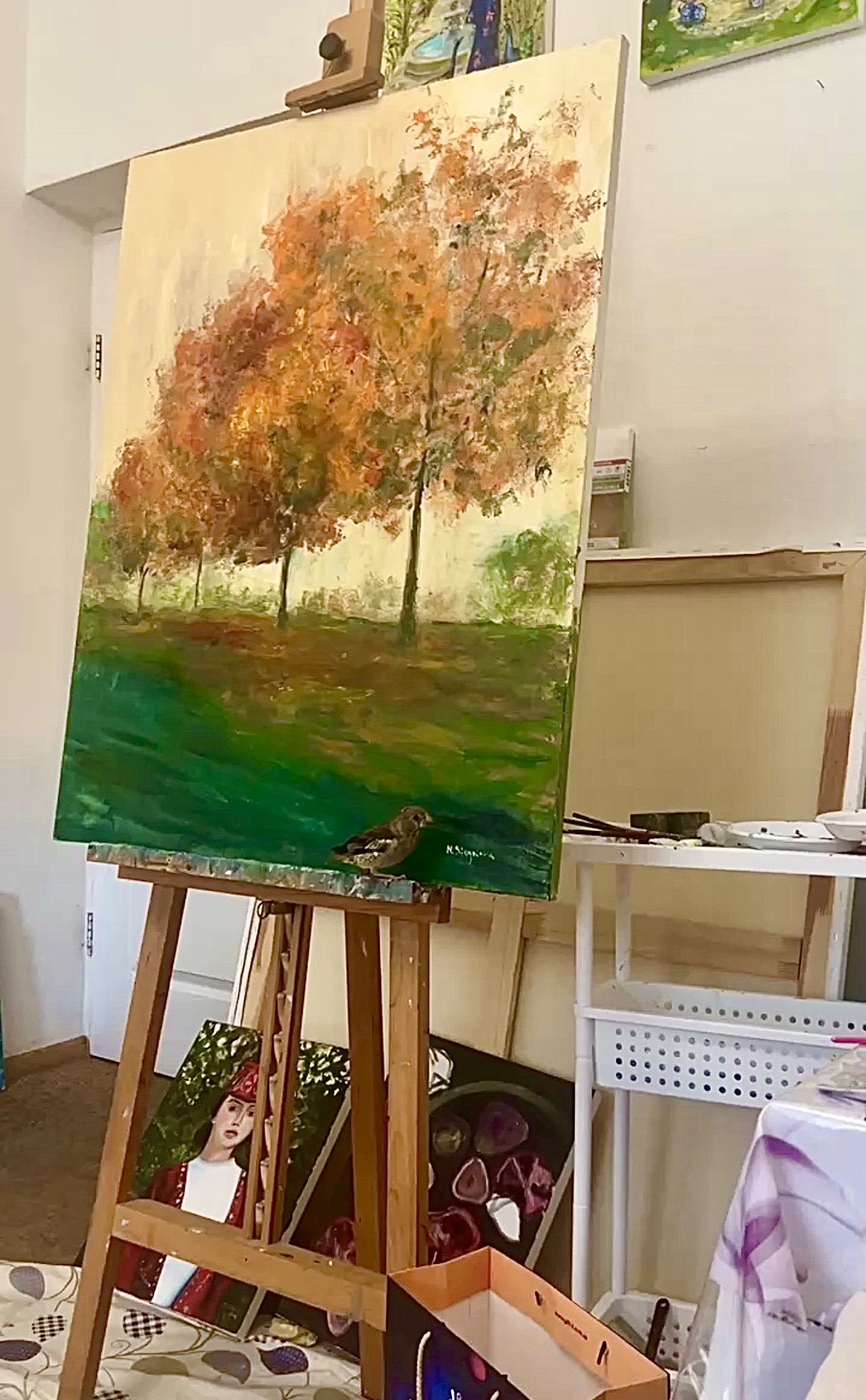 Breath of Autumn. November in Marina Stognieva’s art studio, Kyiv, 2024, with the small wild bird rescued by the artist beside the painting